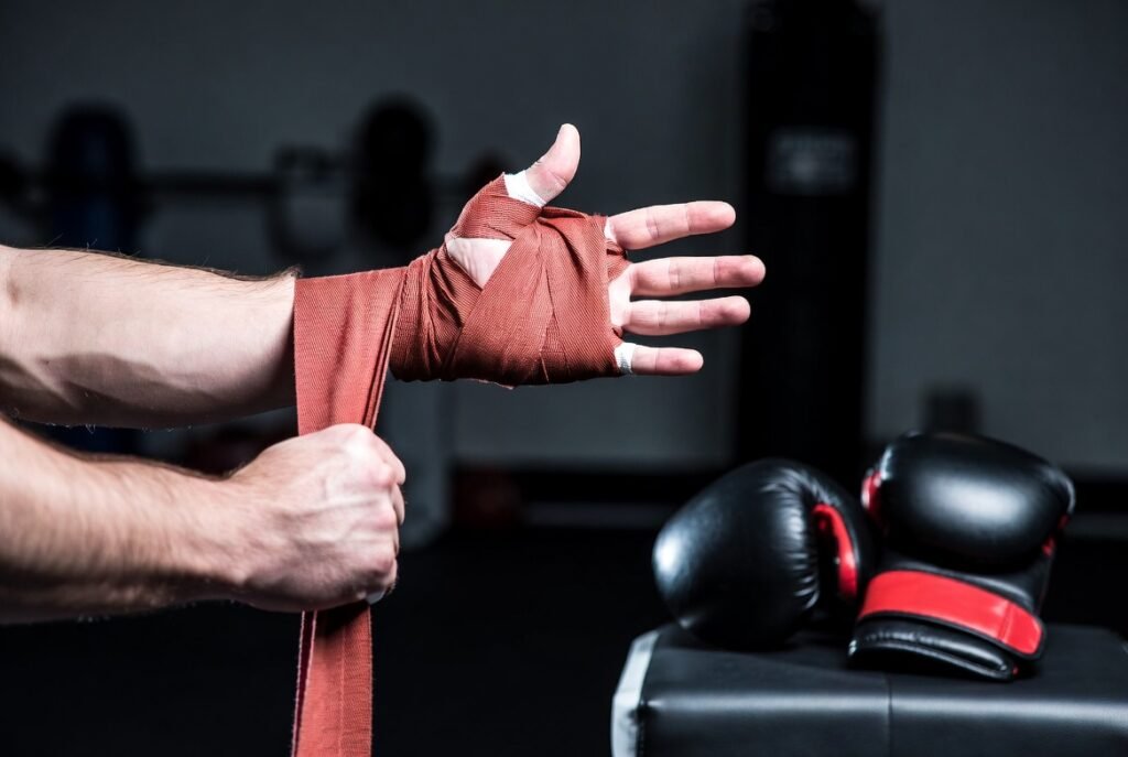How Tight Should Boxing Hand Wraps Be? Best Guide 2026 1 Boxer wrapping hands correctly before boxing training for wrist and knuckle protection in the gym